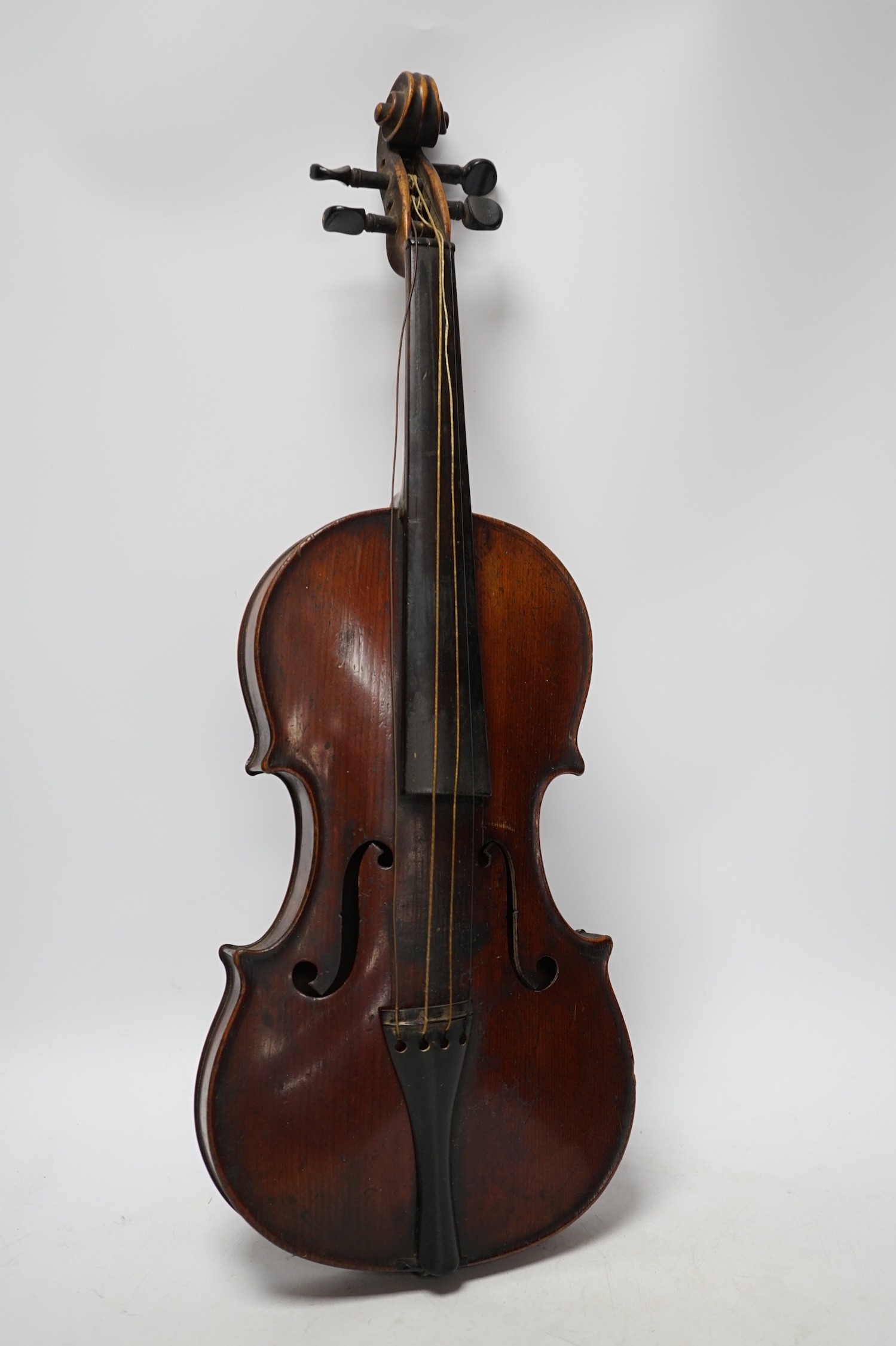 A late 19th century three quarter length violin with label; 'Medio-Fino', back measures 33cm. Condition - fair